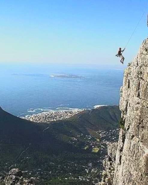 Mark Farmer abseiling a cliff face on Table Mountain above Cape Town