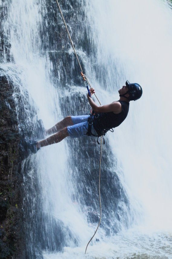 Rappelling down a waterfall face